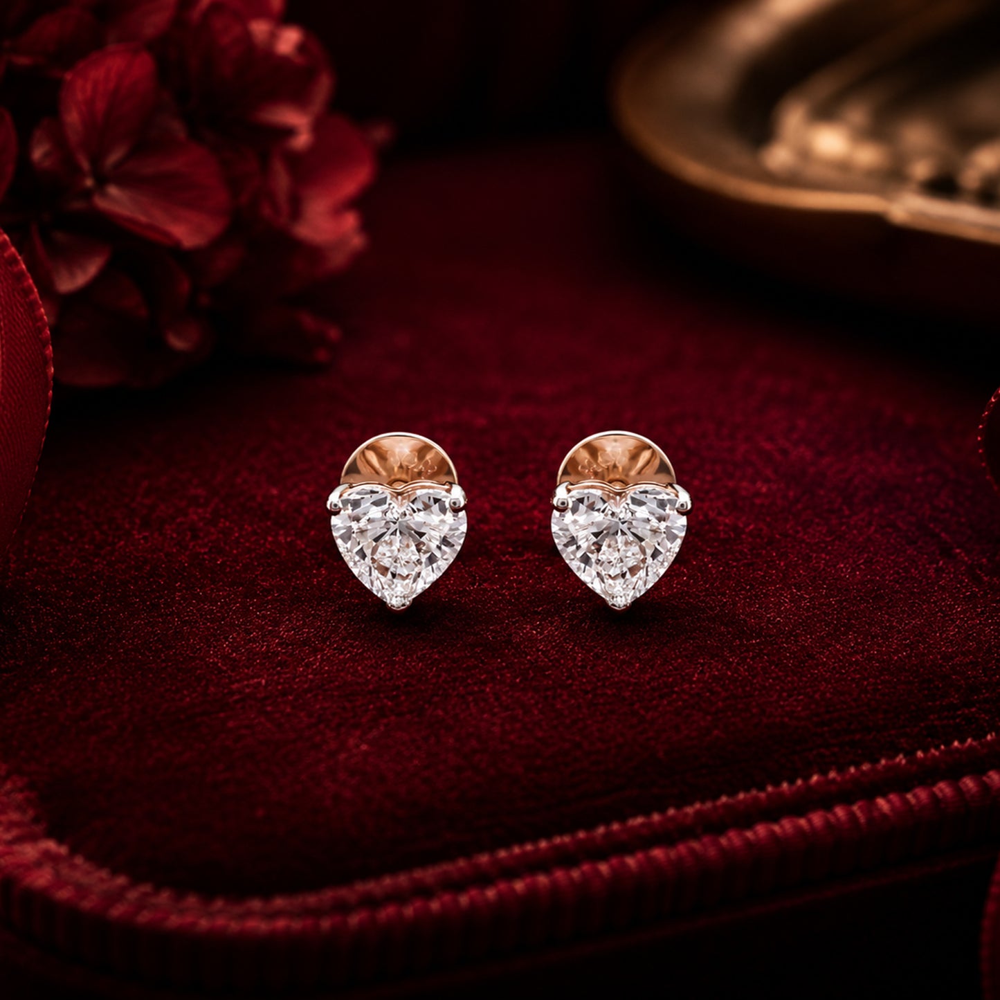 Diamond heart drop earrings with pear and marquise cut diamonds on luxury burgundy velvet backdrop