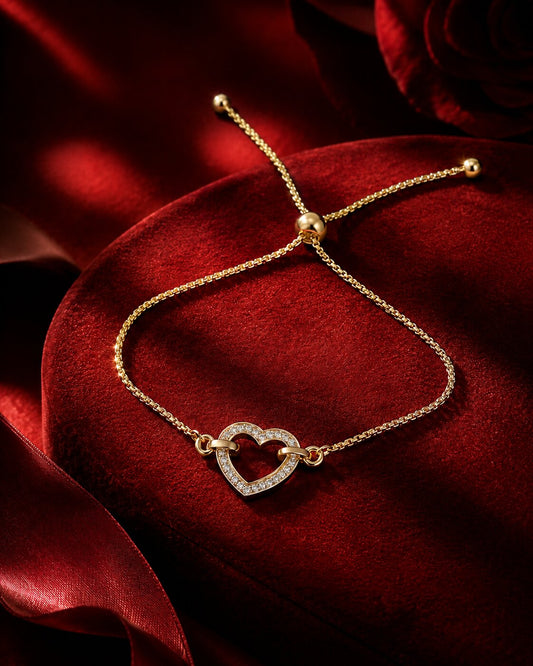 Heart-shaped lab-grown diamond bracelet in yellow gold on red velvet cushion, luxury Firefly Diamonds jewellery campaign photography.