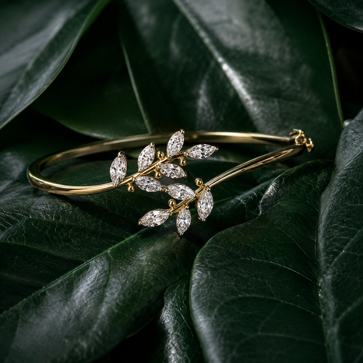 Nature-inspired diamond bracelet in gold with leaf motif on dark green tropical leaves