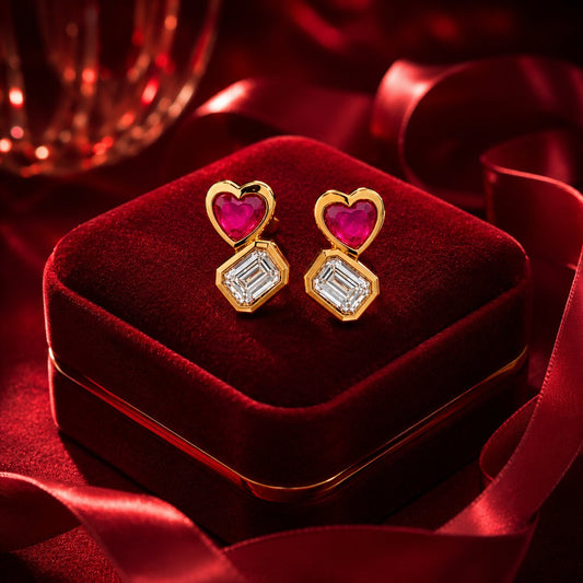 Ruby heart and emerald-cut diamond earrings in yellow gold on burgundy velvet box, luxury Firefly Diamonds jewellery campaign.