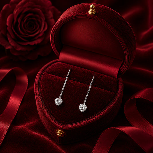 Classic heart diamond stud earrings on red velvet jewellery display with romantic rose backdrop