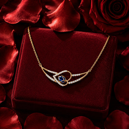 Blue gemstone and diamond necklace in yellow gold on burgundy velvet, romantic luxury jewellery photography.