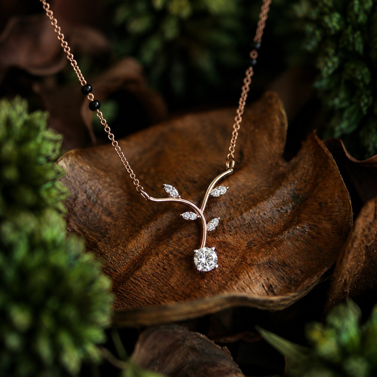 Elegant vine-inspired diamond necklace in gold with organic leaf motif