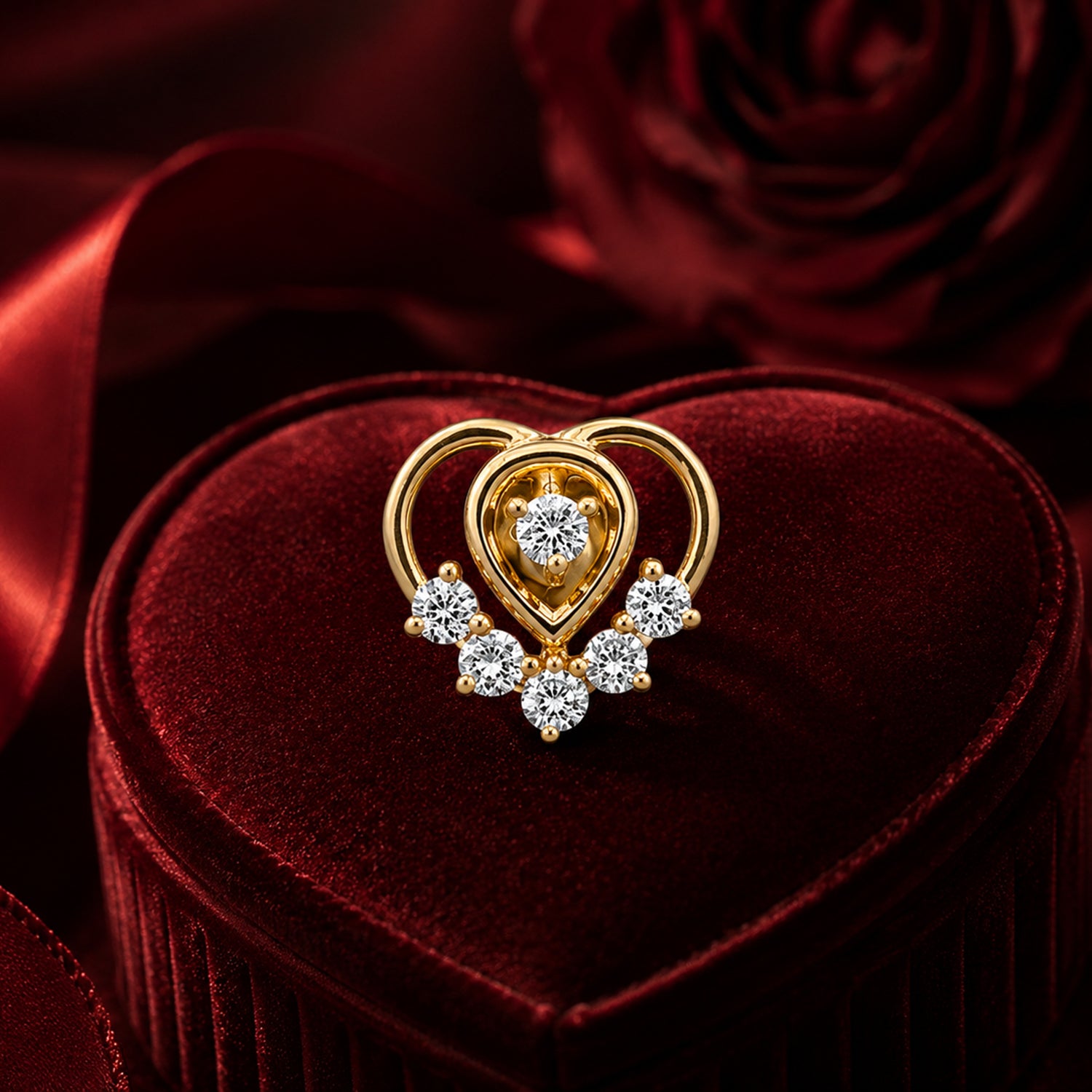 Gold heart diamond pendant with floral cluster design on red velvet jewellery 