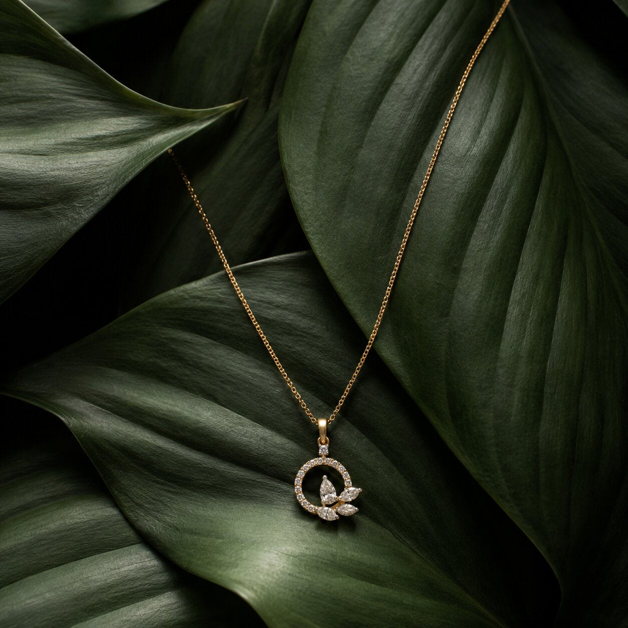 Circular floral diamond pendant necklace in gold with elegant botanical leaf styling