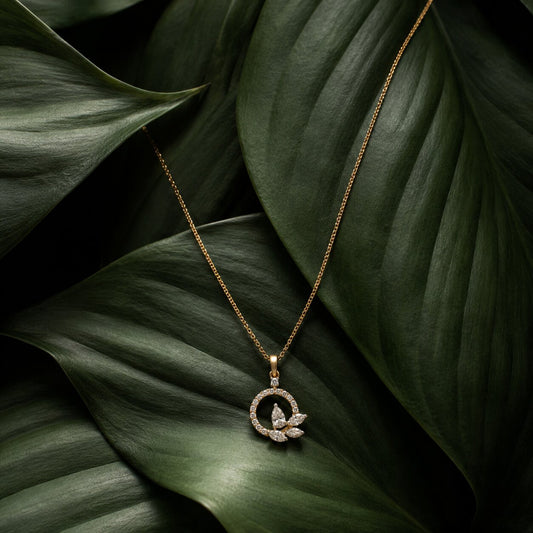 Circular floral diamond pendant necklace in gold with elegant botanical leaf styling
