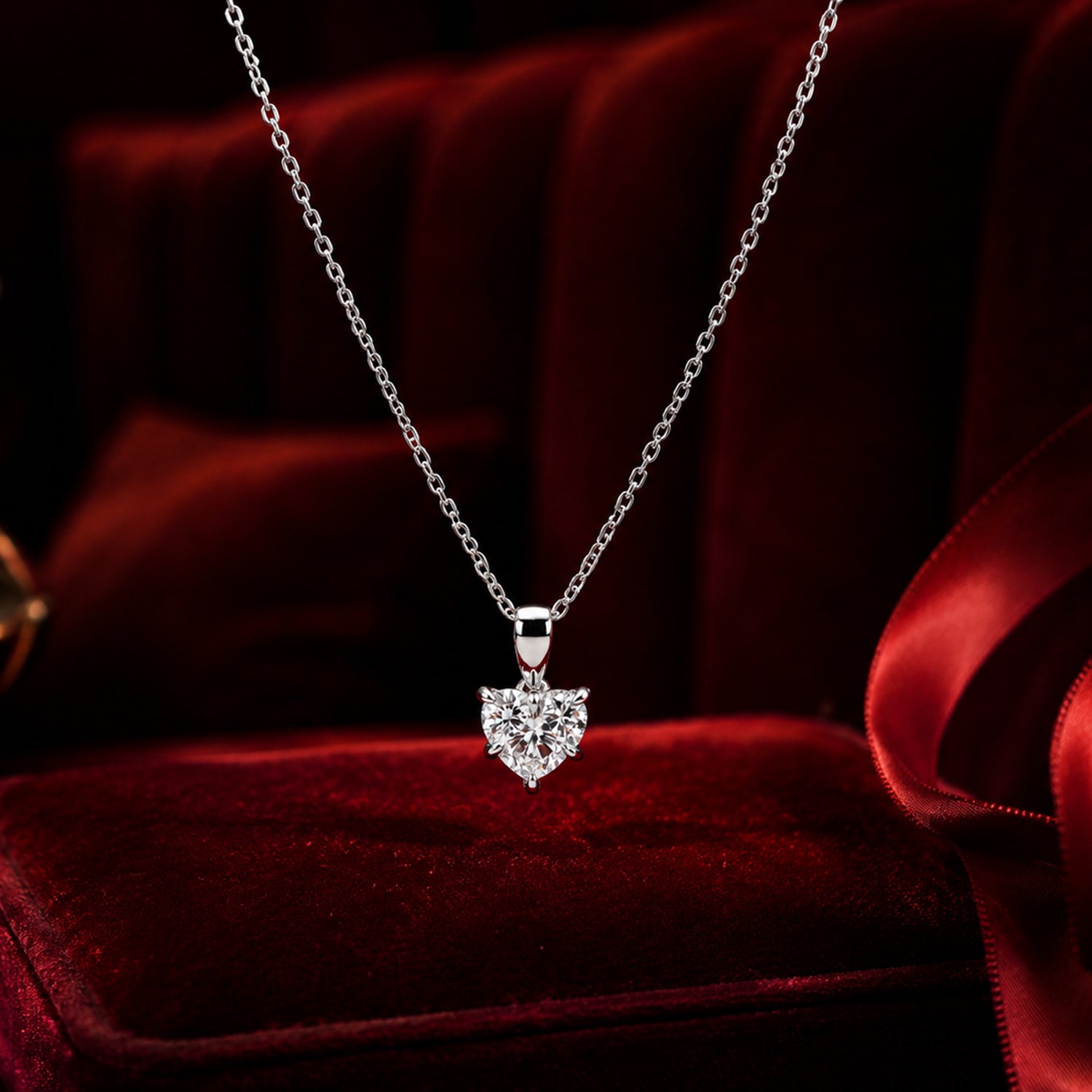 Heart solitaire diamond pendant necklace in white gold with elegant red velvet luxury styling.