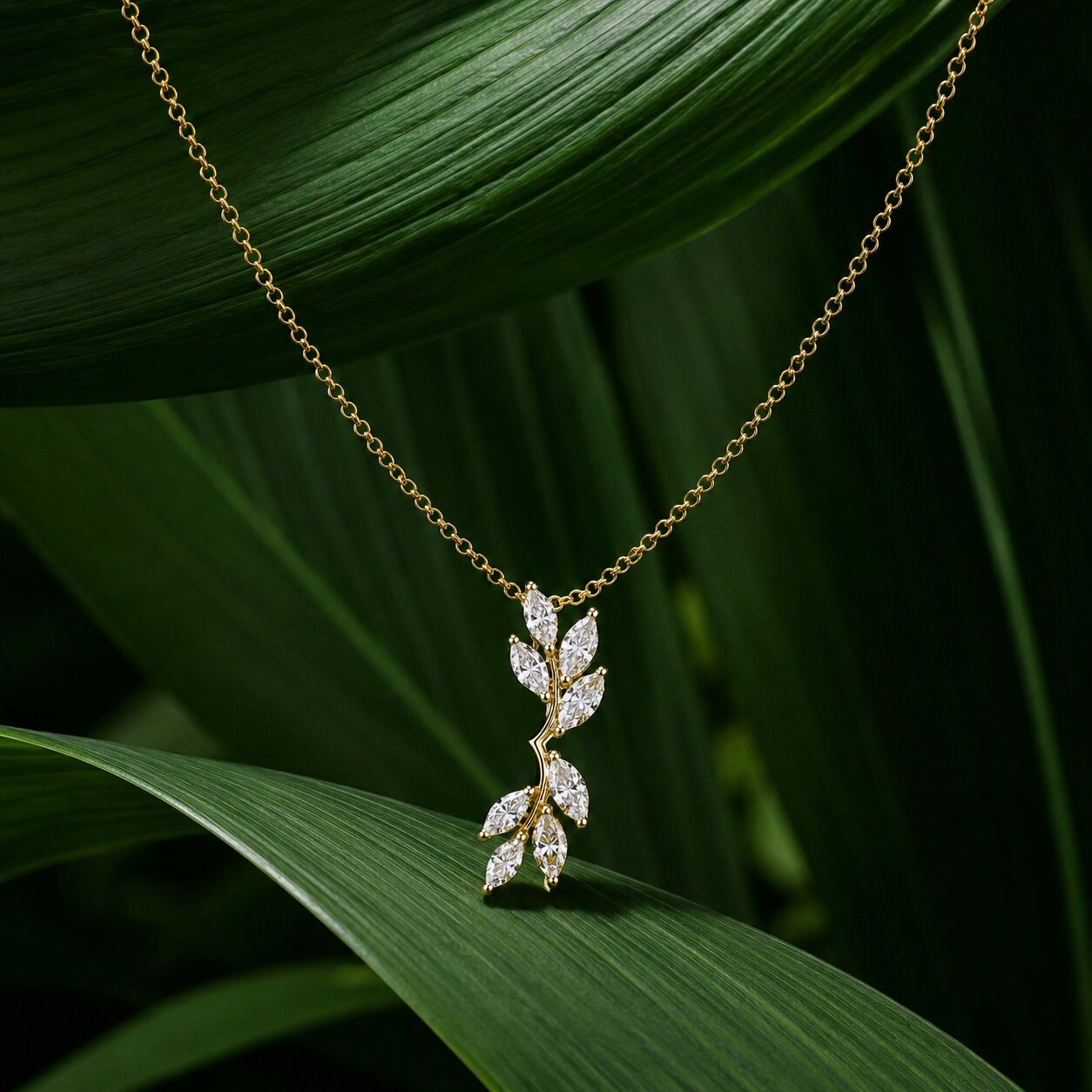 Luxury vine-inspired diamond pendant necklace in gold with marquise lab-grown diamonds and tropical leaf backdrop