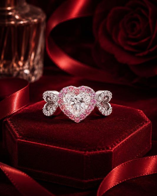 Pink heart diamond ring with butterfly details in luxury red velvet setting.