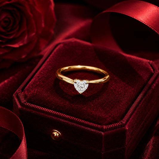 Minimal heart solitaire diamond ring in yellow gold on velvet jewellery box.