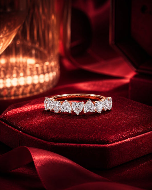 Heart eternity diamond band ring in rose gold on burgundy velvet.