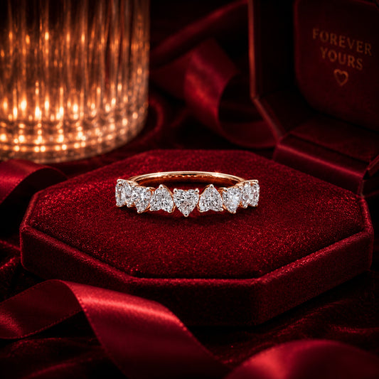 Heart eternity diamond band ring in rose gold on burgundy velvet.