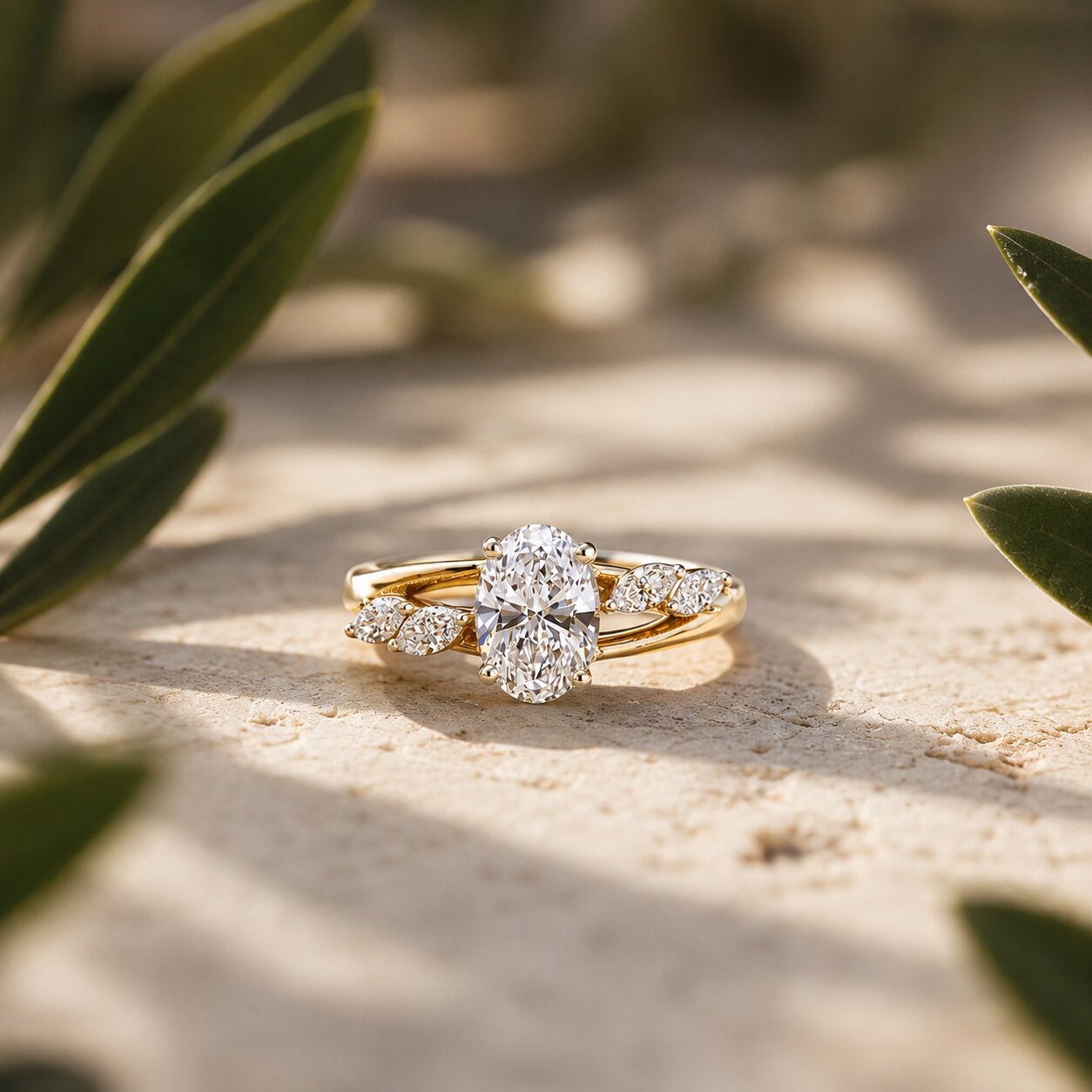 Oval solitaire diamond ring in gold with elegant botanical-inspired side detailing