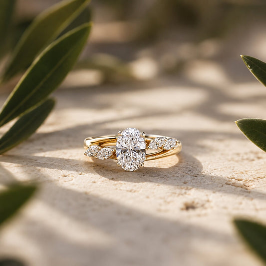 Oval solitaire diamond ring in gold with elegant botanical-inspired side detailing